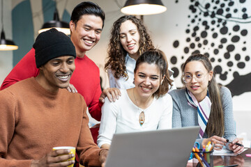 Young co-workers multiethnic team planning a new startup - Happy people working on a new project in creative coworking office - Tech, entrepreneur, marketing concept - Focus on woman face at center