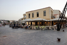  Waterside Restaurants In Early Evening Light At Old Venetian Harbor In Rethymnon. Crete, Greece