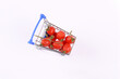Not fresh shrivelled tomatoes in shopping cart.