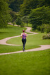© Daniel L/peopleimages.com - In it for the long run. Rearview shot of a woman jogging along a foothpath in a park.