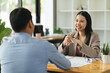 © PaeGAG - Asian business man present and explain work to female colleague, using laptop computer in office. Teamwork, coworker cooperation, financial marketing team, or corporate business concept.