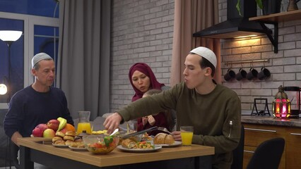 Wall Mural - Food table served during Iftar or suhoor in the Holy Month of Ramadan. Muslim traditional family together having dinner on table at home