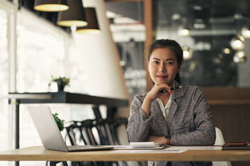 Happy confident Asian business woman looking at camera and smile.