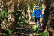Forest Fitness Fanatic. Shot Of A Male Cyclist Riding Along A Mountain Bike Trail.