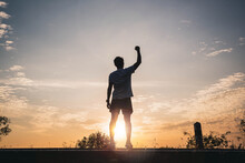 Confident Men Raise Their Hands In The Air For Success, Victory And Power. Sport Man Rise Hand Up On Sunset Sky Background. Freedom And Sport Concept.