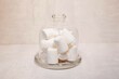 marshmallows in a glass bowl on a concrete background