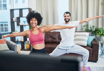 Poster - We learned everything we know from this video. Shot of a couple looking at the television while practising yoga at home.