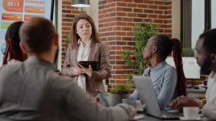 Poster - Close up of woman doing business presentation in boardroom, using charts on monitor as analysis for company development and growth. Person talking to coworkers about project plan.