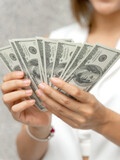 Fototapeta  - close up woman holding money US dollar bills in hand , business concept