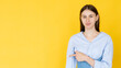 © golubovy - Notice information. Pointing woman. Advertising background. Pretty smiling lady directed hand finger on copy space isolated yellow.