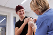 © Johnér - Smiling young man getting vaccinated against Covid-19