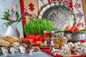 Wall Mural - Traditional Azerbaijan spring holiday Novruz tray with semeni - wheat grass, pakhlava, shekerbura,badambura,mutaki,gogal,flowers,dry fruits,spring flowers.