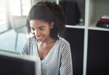 Poster - She has a killer work ethic. Cropped shot of a young businesswoman working on her computer at her desk.