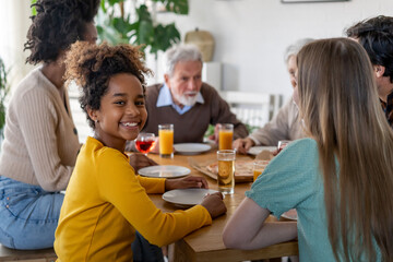 Wall Mural - Multiethnic diverse extended family dining and toasting together