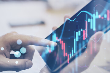 Aufkleber - Close up of hand using digial tablet at desktop with glowing forex chart on blurry background. Trade, finance and stock concept. Double exposure.