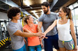 © NDABCREATIVITY - Portrait of happy fit people, friends exercising in gym together. Sport people workout concept