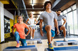 © NDABCREATIVITY - Portrait of happy fit people, friends exercising in gym together. Sport people workout concept