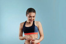 Slim Young Woman Measuring Her Thin Waist With A Tape Measure, Close Up. Weight Losing Concept.
