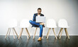 © Arnéll K/peopleimages.com - Familiarizing myself with the ins and outs of the company. Shot of a young businessman using a laptop while waiting in line.