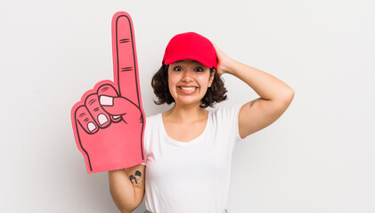 Wall Mural - pretty hispanic girl feeling stressed, anxious or scared, with hands on head. number one hand fan concept