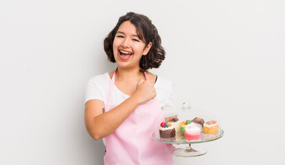 Wall Mural - pretty hispanic girl feeling happy and facing a challenge or celebrating. home made cakes concept