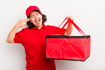 Wall Mural - pretty hispanic girl looking unhappy and stressed, suicide gesture making gun sign. fast food delivery concept