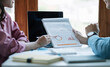 © Natee Meepian - Business People Meeting to analyse and discuss and brainstorming the financial report chart data in office Financial advisor teamwork and accounting concept
