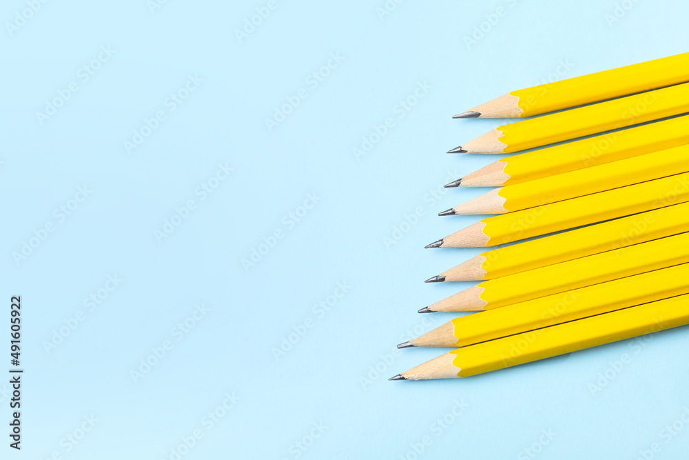 Many ordinary pencils on color background, closeup
