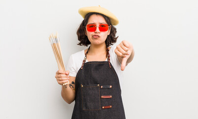 Wall Mural - pretty hispanic girl feeling cross,showing thumbs down. art student concept