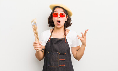 Wall Mural - pretty hispanic girl feeling extremely shocked and surprised. art student concept