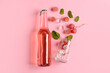 Composition with bottle of fresh soda on pink background