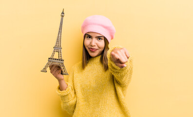 pretty hispanic girl pointing at camera choosing you. paris concept