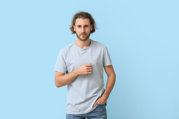 Sticker - Handsome young man in stylish t-shirt on blue background