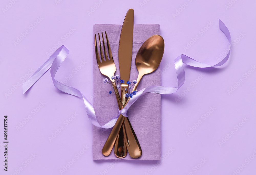 Simple table setting with flowers on purple background