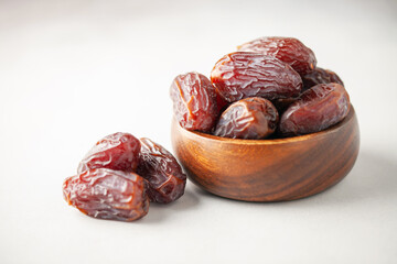 Dried dates on saucer ready to eat for iftar time. Islamic religion and ramadan concept.