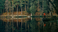 Woman And Reflections On A Lake