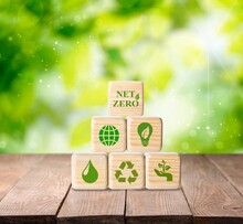 Net Zero And Carbon Neutral Concept. Put Wooden Cubes With Green Net Zero Icon