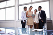 © T Hover/peopleimages.com - Defining the scope of their project. Shot of a group of businesspeople standing together looking at a digital tablet.