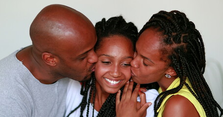 Wall Mural - Parents kissing teenager dauther on the cheek. Black mixed race African family love and affection