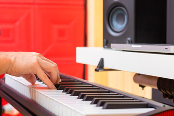 Wall Mural - close up male musician hands playing midi piano for arranging music or practicing piano lesson