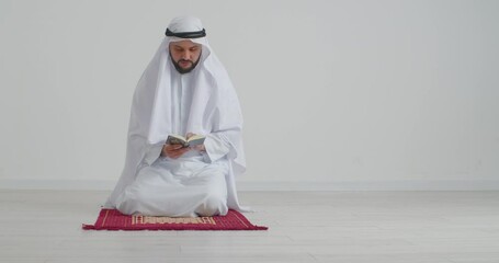 Poster - Muslim man reading Koran in light room