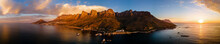 Panoramic Aerial View Of Victoria Road With Lions Head And Twelve Apostles Mountains At Sunset, Cape Town, South Africa.