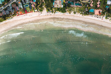 Aerial Top Down View Of Many Surfers In The Indian Ocean Waiting For The Wave On Famous Weligama Beach In Sri Lanka.