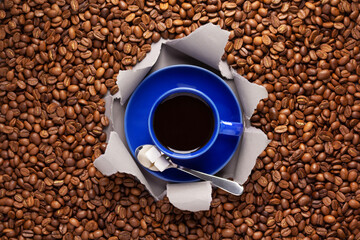 Wall Mural - Cup of coffee and beans in torn paper. Coffee ingredients with espresso