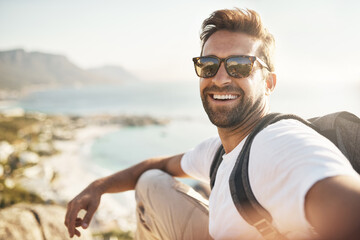 selfies with a view. cropped portrait of a handsome young man taking selfies while hiking in the mou