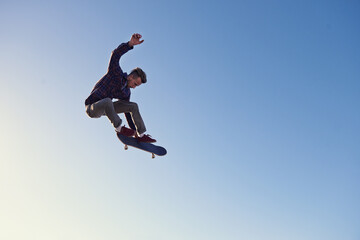 Sticker - A rad day at the skate park. A young man doing tricks on his skateboard at the skate park.