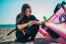 Woman Using Flying Lines And A Control Bar For Kitesurfing