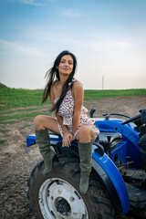 Wall Mural - Girl with long black hair in the countryside. Ipadrome with horses. Rural landscapes, wild west.