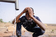 Young African boy washing his face at the village tap: World Water Day recurrence