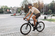 © Tymoshchuk - Muscular man riding bike on city street
